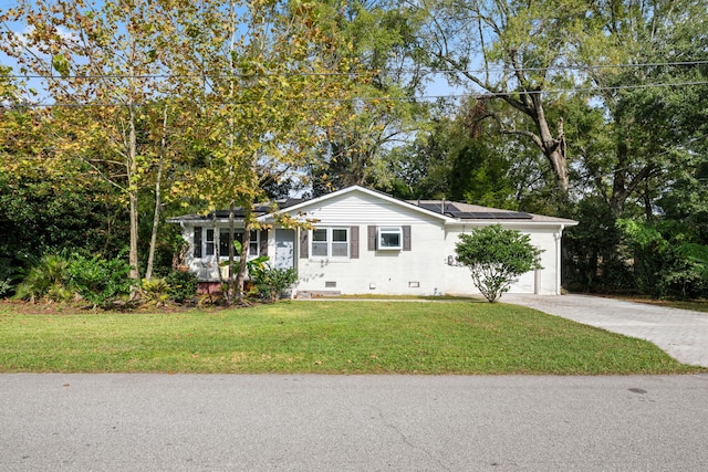 ranch-style home featuring solar panels and a front lawn