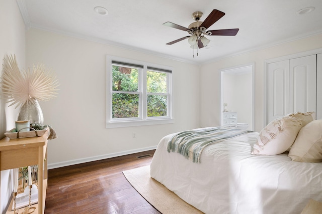 bedroom with ceiling fan, dark hardwood / wood-style floors, and ornamental molding