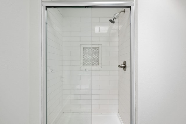 bathroom with a tile shower