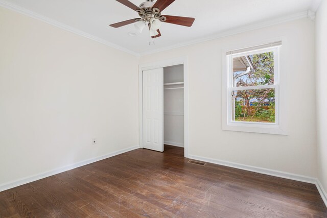 unfurnished bedroom with ceiling fan, dark hardwood / wood-style flooring, and ornamental molding