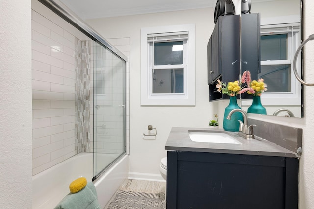 full bathroom with vanity, toilet, wood-type flooring, and enclosed tub / shower combo