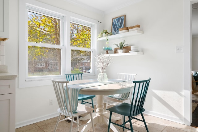 tiled dining space featuring crown molding