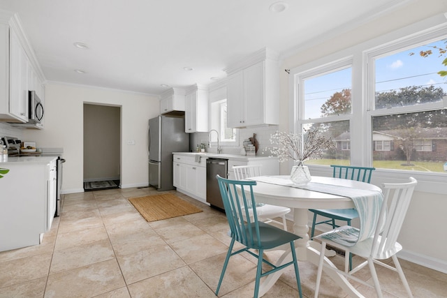 tiled dining area featuring crown molding