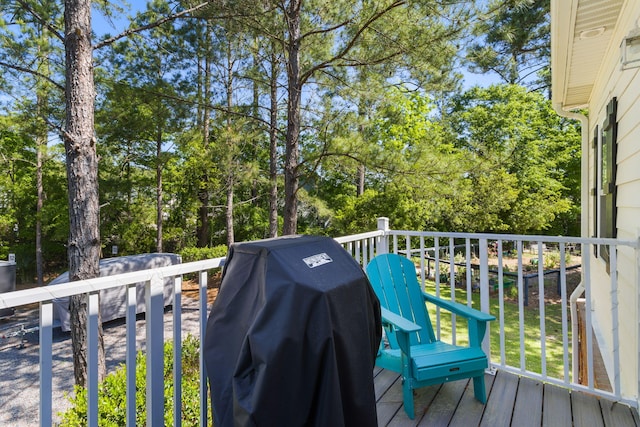 view of wooden balcony with a deck and grilling area