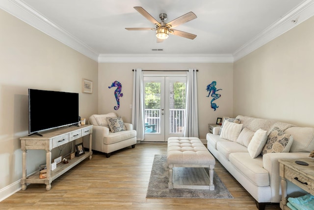 living area featuring baseboards, light wood-style flooring, ceiling fan, ornamental molding, and french doors