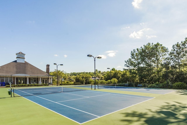 view of tennis court featuring fence