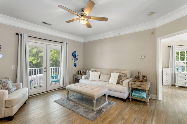 living room featuring french doors, wood finished floors, visible vents, and crown molding