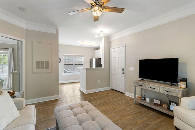 living room featuring ornamental molding, plenty of natural light, and wood finished floors