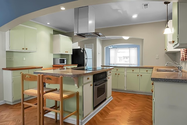 kitchen featuring a kitchen island, island range hood, sink, stainless steel appliances, and light parquet flooring