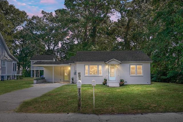 single story home with a carport and a lawn