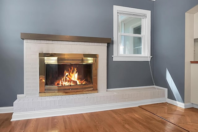 room details with parquet floors and a brick fireplace