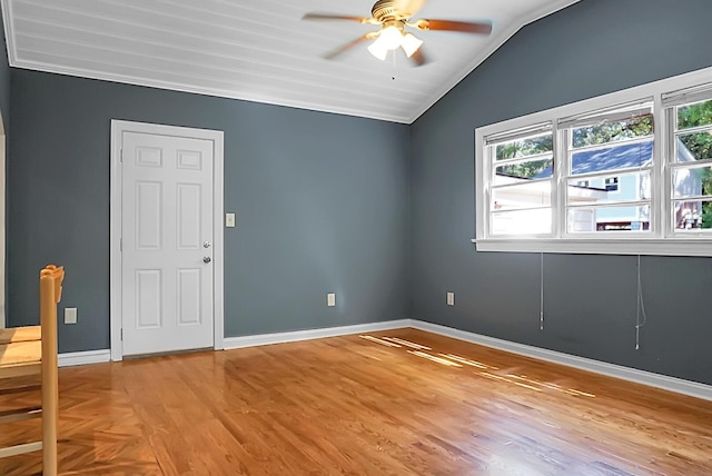 empty room with ceiling fan, plenty of natural light, lofted ceiling, and light hardwood / wood-style floors