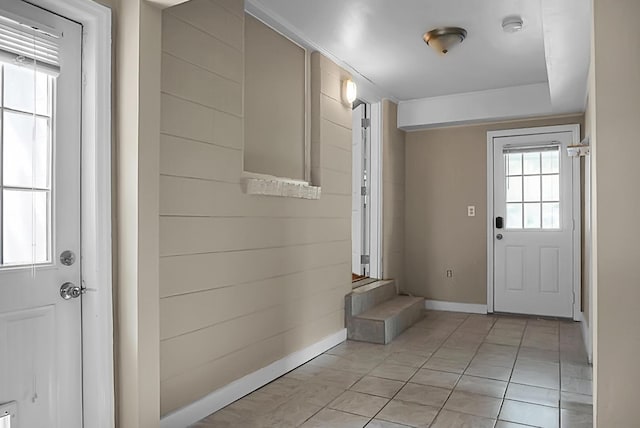 doorway with light tile patterned floors