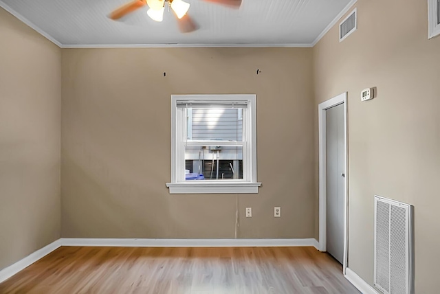 spare room featuring crown molding, light hardwood / wood-style floors, and ceiling fan