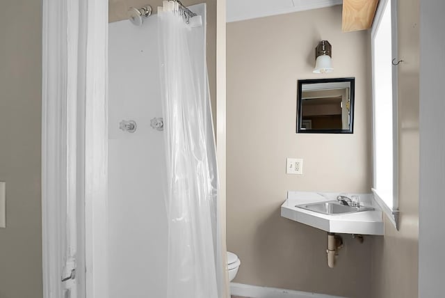 bathroom featuring toilet and sink