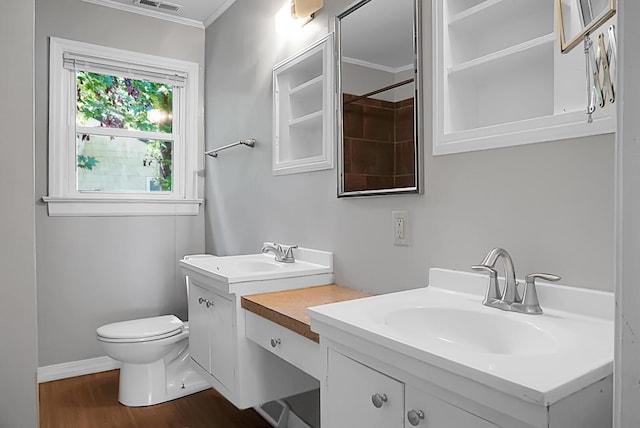 bathroom with vanity, crown molding, wood-type flooring, and toilet