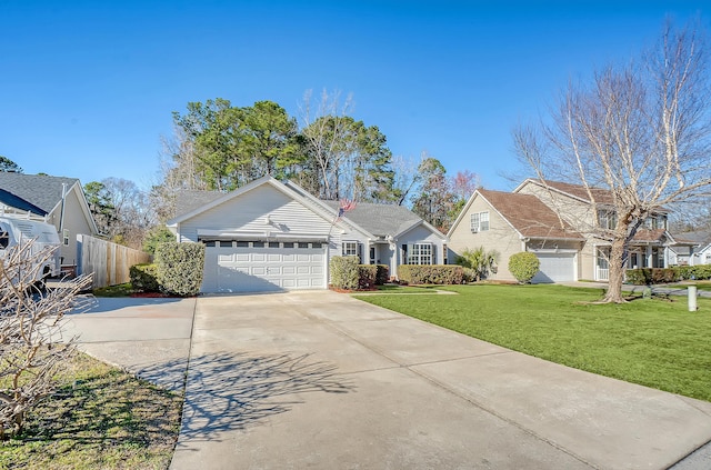 view of front of house featuring a front lawn, driveway, an attached garage, and fence