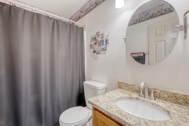 bathroom with vanity, toilet, and a shower with curtain