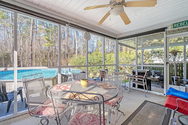 sunroom featuring a ceiling fan and a healthy amount of sunlight