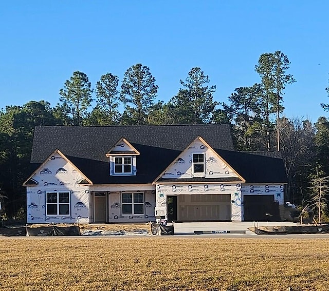 unfinished property with a front lawn and a garage