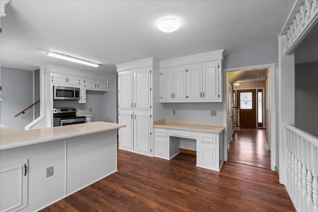 kitchen featuring kitchen peninsula, dark hardwood / wood-style flooring, white cabinets, and stainless steel appliances