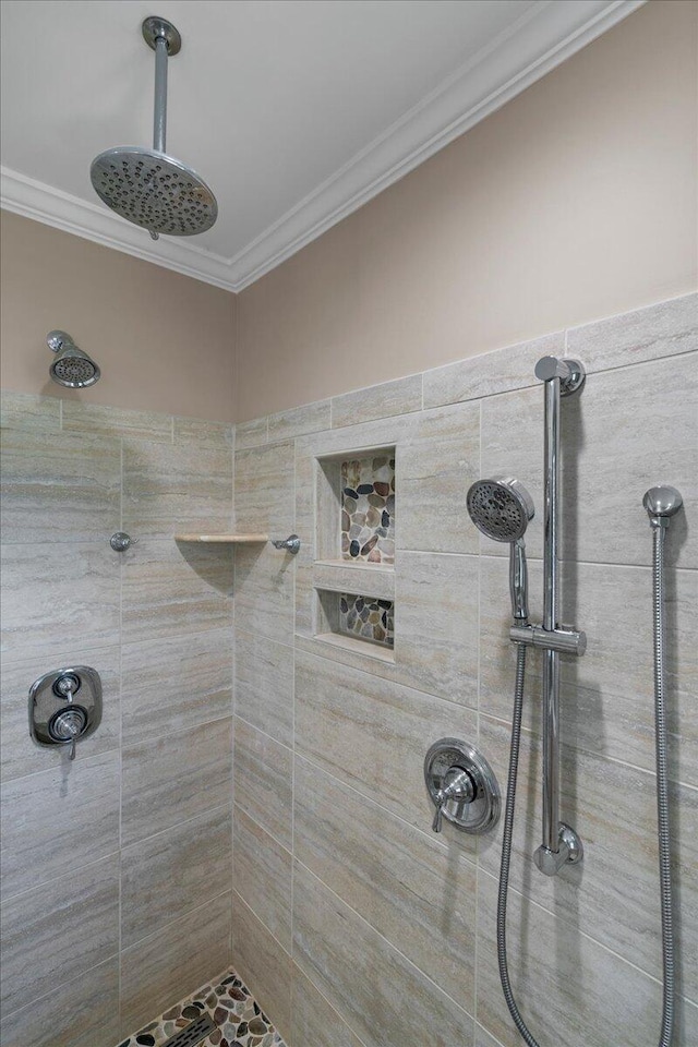 bathroom featuring ornamental molding and tiled shower