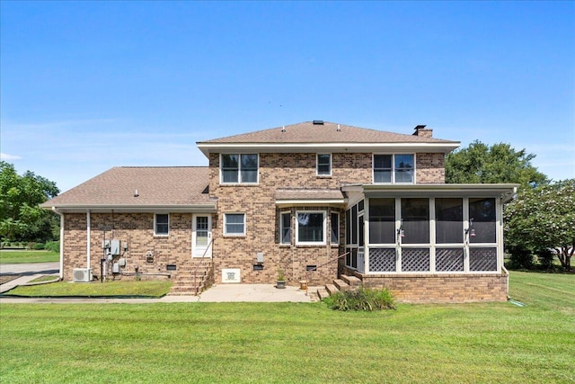 back of property featuring a sunroom, central air condition unit, and a lawn