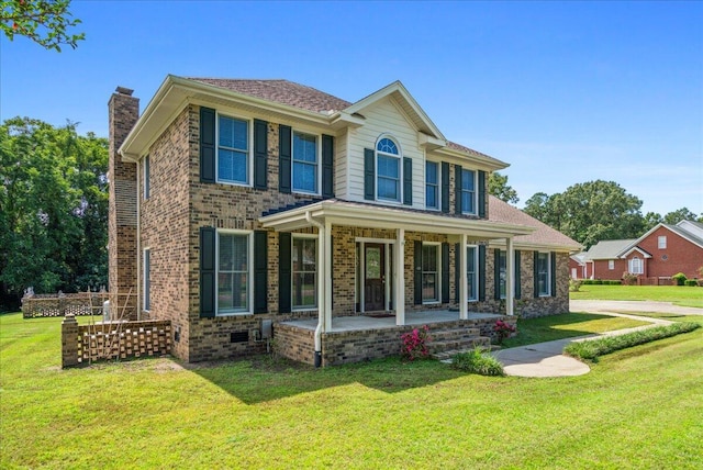 colonial inspired home featuring a front yard and a porch