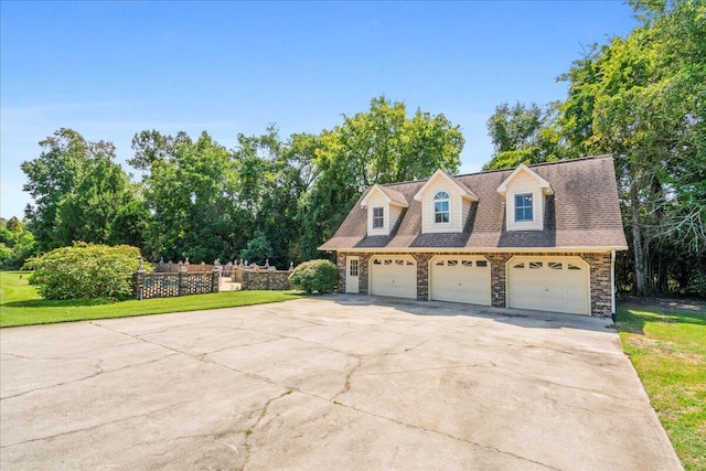 exterior space featuring a garage and a front lawn