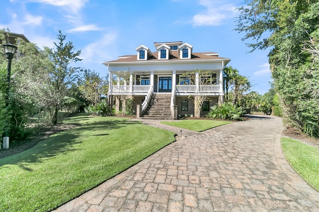 raised beach house with a porch and a front yard