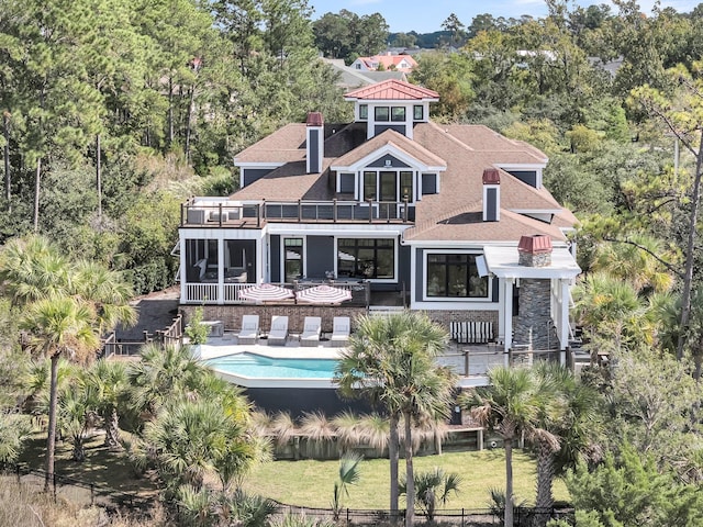 1913 Mooring Line Way, Mount Pleasant, SC 29466 - back of house with fence, a balcony, an outdoor pool, roof with shingles, and a chimney