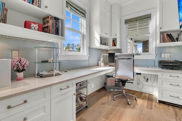 office area featuring built in desk and light hardwood / wood-style flooring