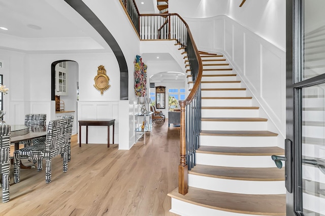 1913 Mooring Line Way, Mount Pleasant, SC 29466 - stairs with arched walkways, wainscoting, wood finished floors, and a decorative wall