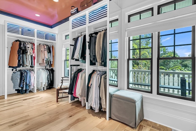 walk in closet with light wood-type flooring