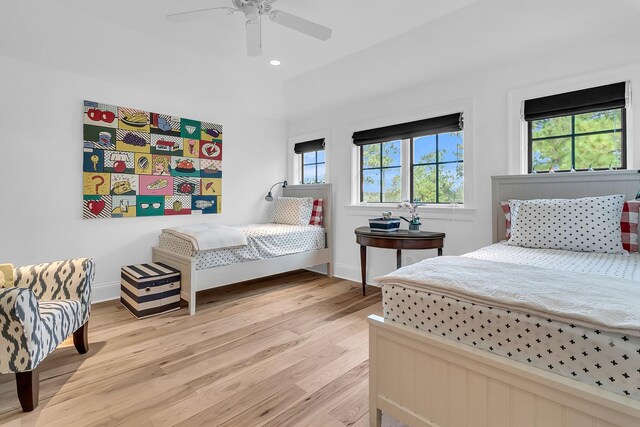 bedroom with light hardwood / wood-style floors and ceiling fan