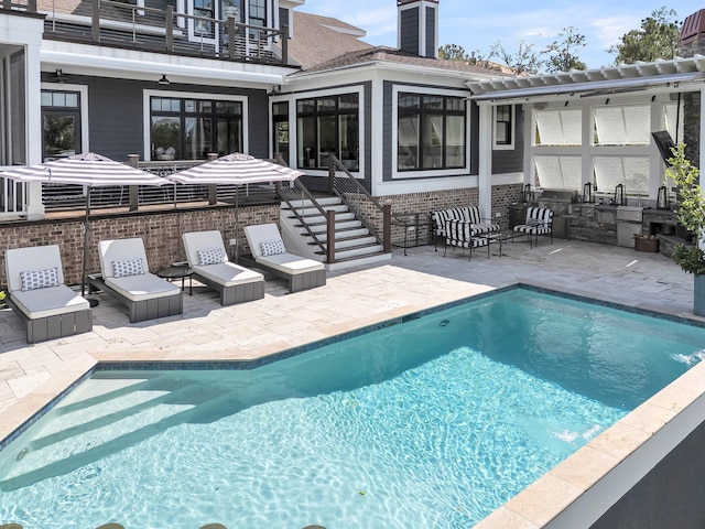 view of pool with a patio area and ceiling fan