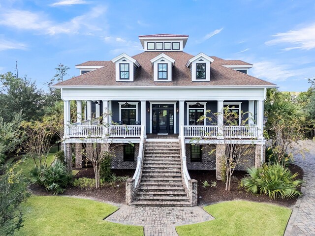 view of front of property with a porch and a front lawn