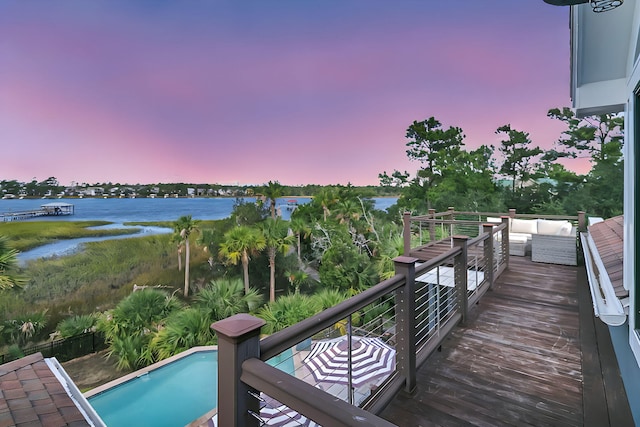 exterior space with a water view and outdoor lounge area