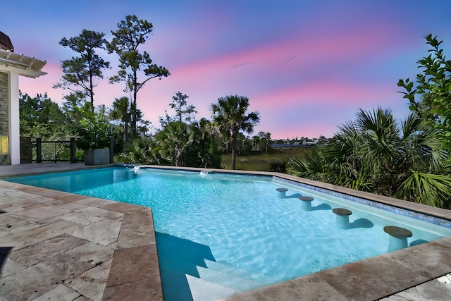 view of pool at dusk