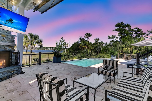 1913 Mooring Line Way, Mount Pleasant, SC 29466 - pool at dusk featuring an outdoor stone fireplace, a fenced in pool, and a patio