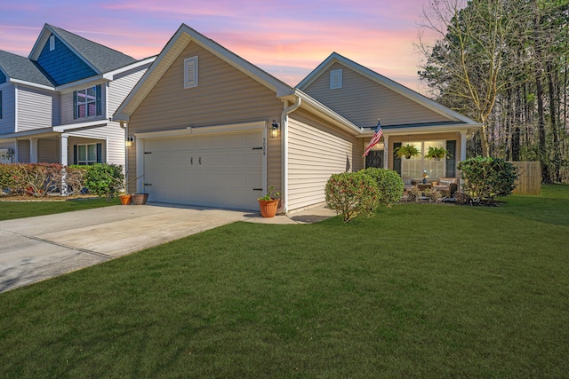 view of front of property featuring an attached garage, driveway, and a front yard