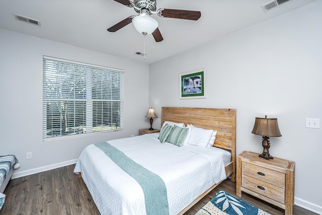 bedroom featuring wood finished floors, visible vents, and baseboards