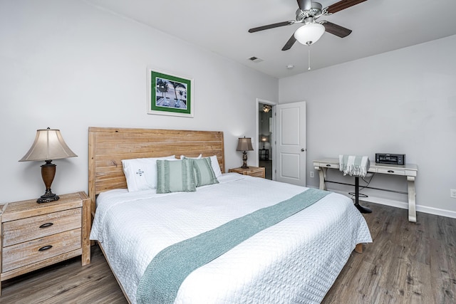 bedroom featuring a ceiling fan, visible vents, baseboards, and wood finished floors