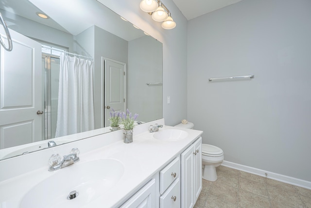 full bath with toilet, baseboards, and a sink