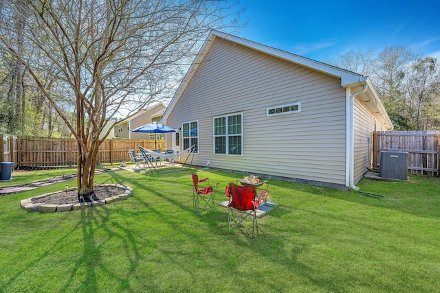 back of property with fence private yard, a patio area, cooling unit, and a yard