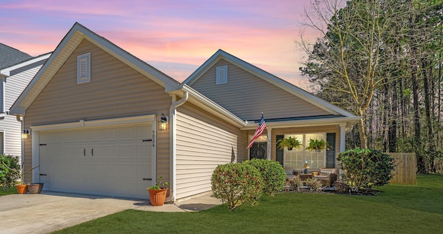 view of front of property with an attached garage, driveway, and a front yard