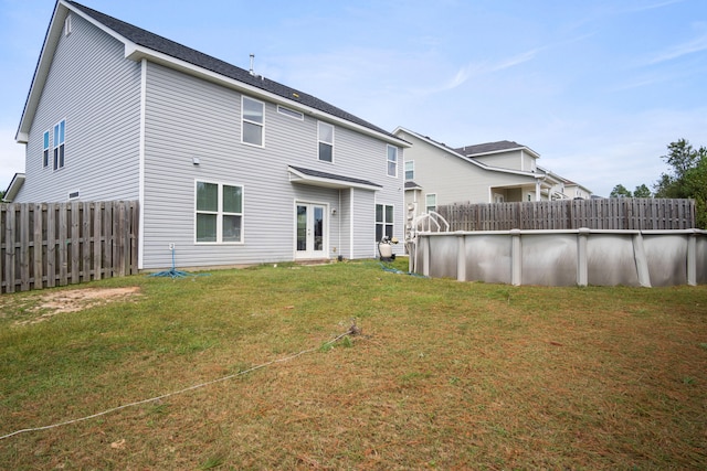 back of house featuring a yard