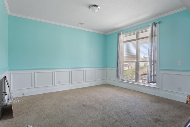 empty room featuring light colored carpet and crown molding