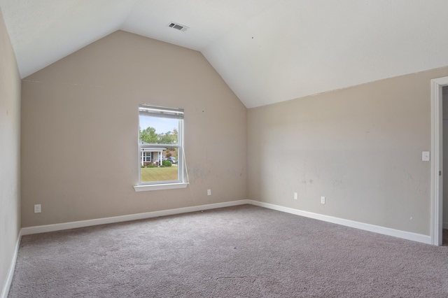 bonus room with carpet flooring and vaulted ceiling