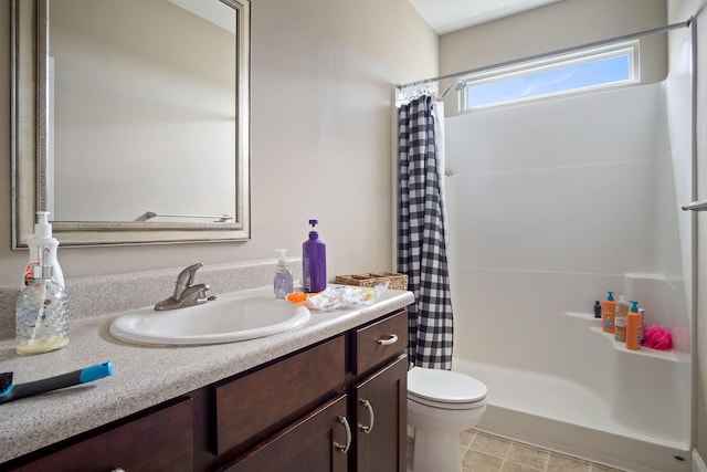 bathroom featuring walk in shower, vanity, and toilet